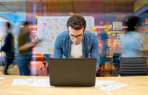 Founder working on their pitch deck at a startup accelerator office.